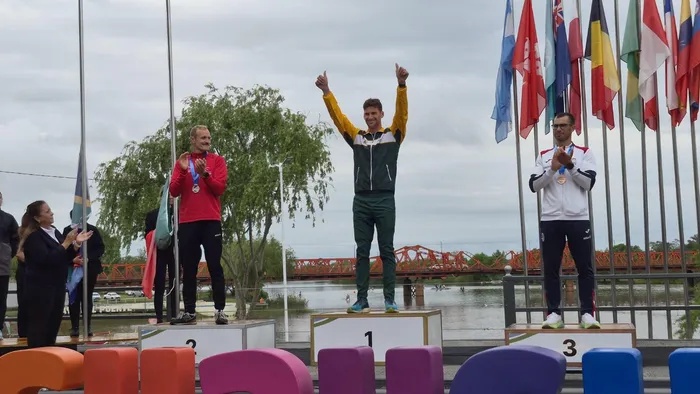 Hamish Lovemore celebrates on the podium after winning gold in the men's K1 short race at the ICF Canoe Marathon World Championships in Gualeguaychú, Argentina.