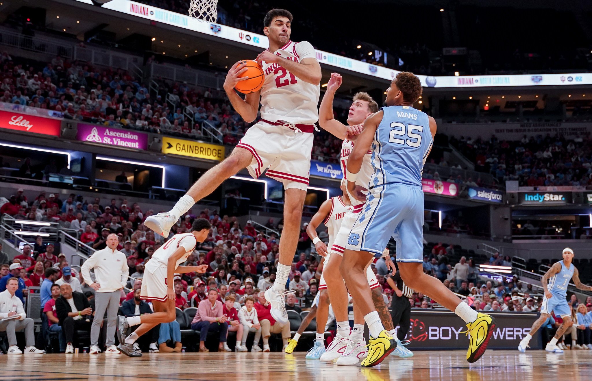 Oct 18, 2026; Indianapolis, IN, USA; Indiana Hoosiers center Samet Yigitoglu (21) rebounds the ball against North Carolina Tar Heels forward Maximo Adams (25) during the first half at Gainbridge Fieldhouse. Mandatory Credit: Robert Goddin-Imagn Images