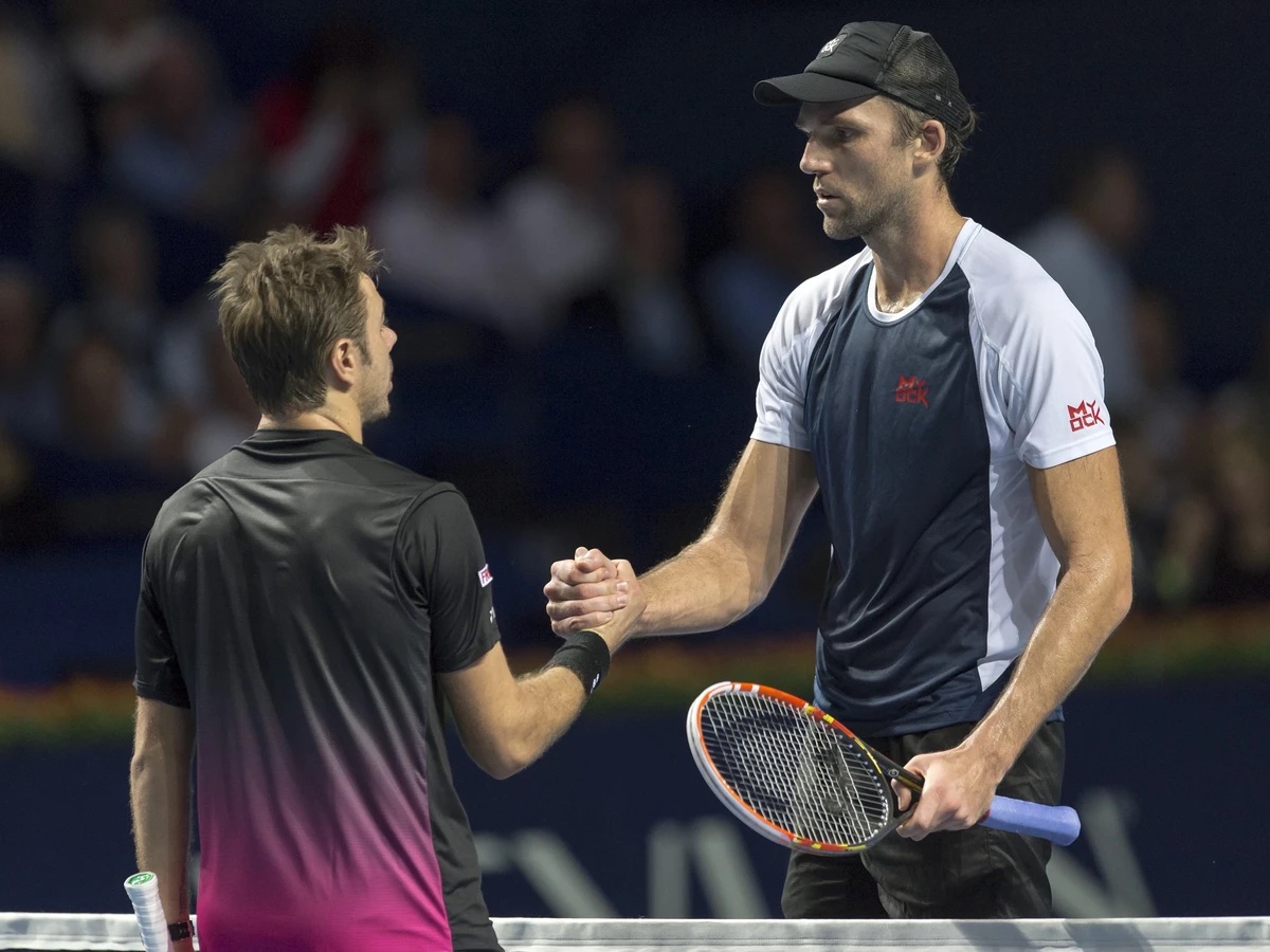 Switzerland's Stan Wawrinka, left, congratulates Croatia's Ivo Karlovic, right, after their first round match at the Swiss Indoors tennis tournament at the St. Jakobshalle in Basel, Switzerl ...