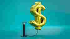computer generated image of on a US dollar sign on a blue background. Monetary inflation concept.