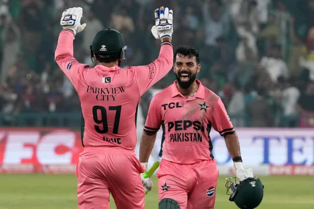 Shadab, right, and Haris Rauf celebrate victory over England. Photo: AP Photo/K.M. Chaudary