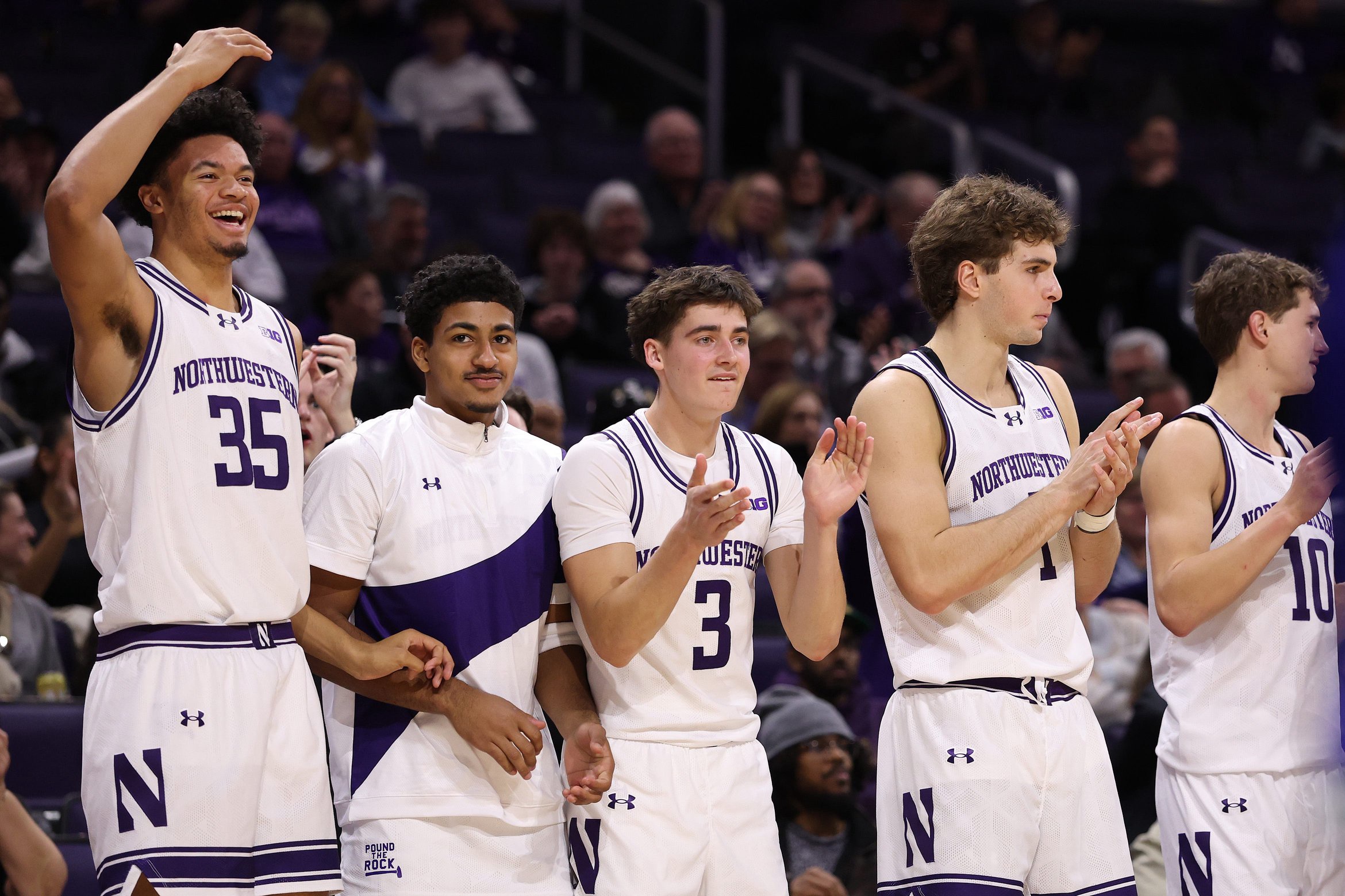 EVANSTON, ILLINOIS - NOVEMBER 03: Cade Bennerman #35, Phoenix Gill #13, Jake West #3, Tyler Kropp #1, and Max Green #10 of the Northwestern Wildcats celebrate a dunk against the Mercyhurst Lakers during the second half at Welsh-Ryan Arena on November 03, 2025 in Evanston, Illinois. (Photo by Michael Reaves/Getty Images)