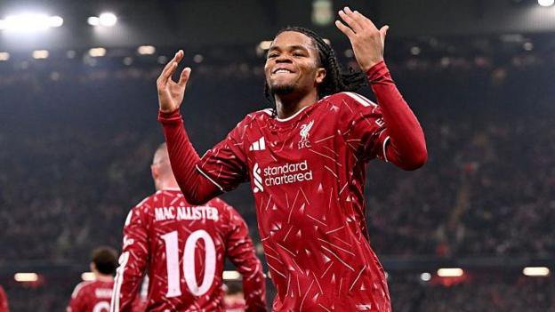 Rio Ngumoha celebrates with his arms raised in a happy gesture