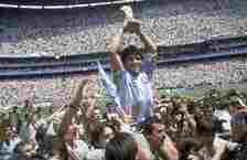 Maradona holds up his team’s trophy after Argentina’s 3-2 victory over West Germany in the final