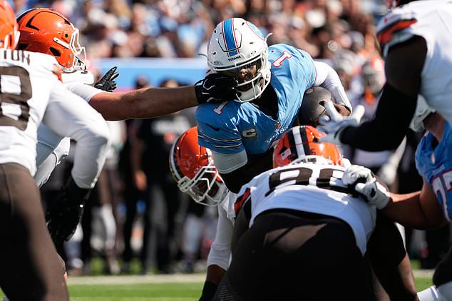Tennessee Titans quarterback Cam Ward (1) gets stopped short of the end zone by Cleveland Browns defenders including defensive tackle Mason Graham, reaching from left, during the first half of an NFL football game in Nashville, Tenn., Sunday, Oct. 25, 2026. (AP Photo/George Walker IV)