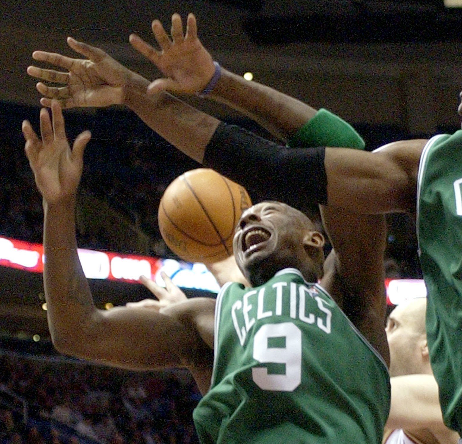Justin Reed (9) of the Boston Celtics has the ball batted away by Zydrunas Ilgauskas (behind) of the Cleveland Cavaliers in the fourth quarter of their NBA game at the Q Arena in Cleveland, Ohio November 22, 2005. Cavaliers won 115-93. REUTERS/Ron Kuntz