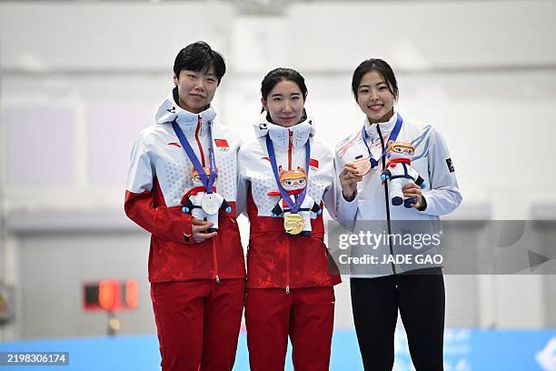 Gold and silver medallists chinas han mei and yin qi and bronze medallist south koreas lee na