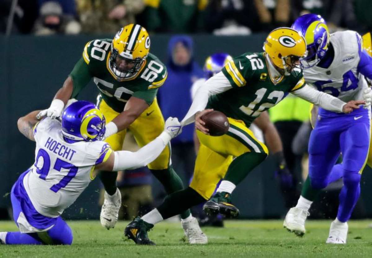 Green Bay Packers quarterback Aaron Rodgers (12) scrambles as guard Zach Tom (50) blocks Los Angeles Rams defensive tackle Michael Hoecht (97) during their football game on Monday December, 19, 2022 at Lambeau Field in Green Bay, Wis. Wm. Glasheen USA TODAY NETWORK-Wisconsin Apc Packers Vs Rams 81650 121922 Wag