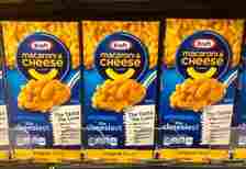Several Boxes of Kraft Mac & Cheese on shelve at a grocery store .