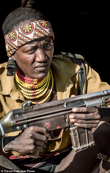 The Omo Valley is home to eight different tribes with a collective population of 200,000 people. Pictured: A Suri tribesperson with a gun