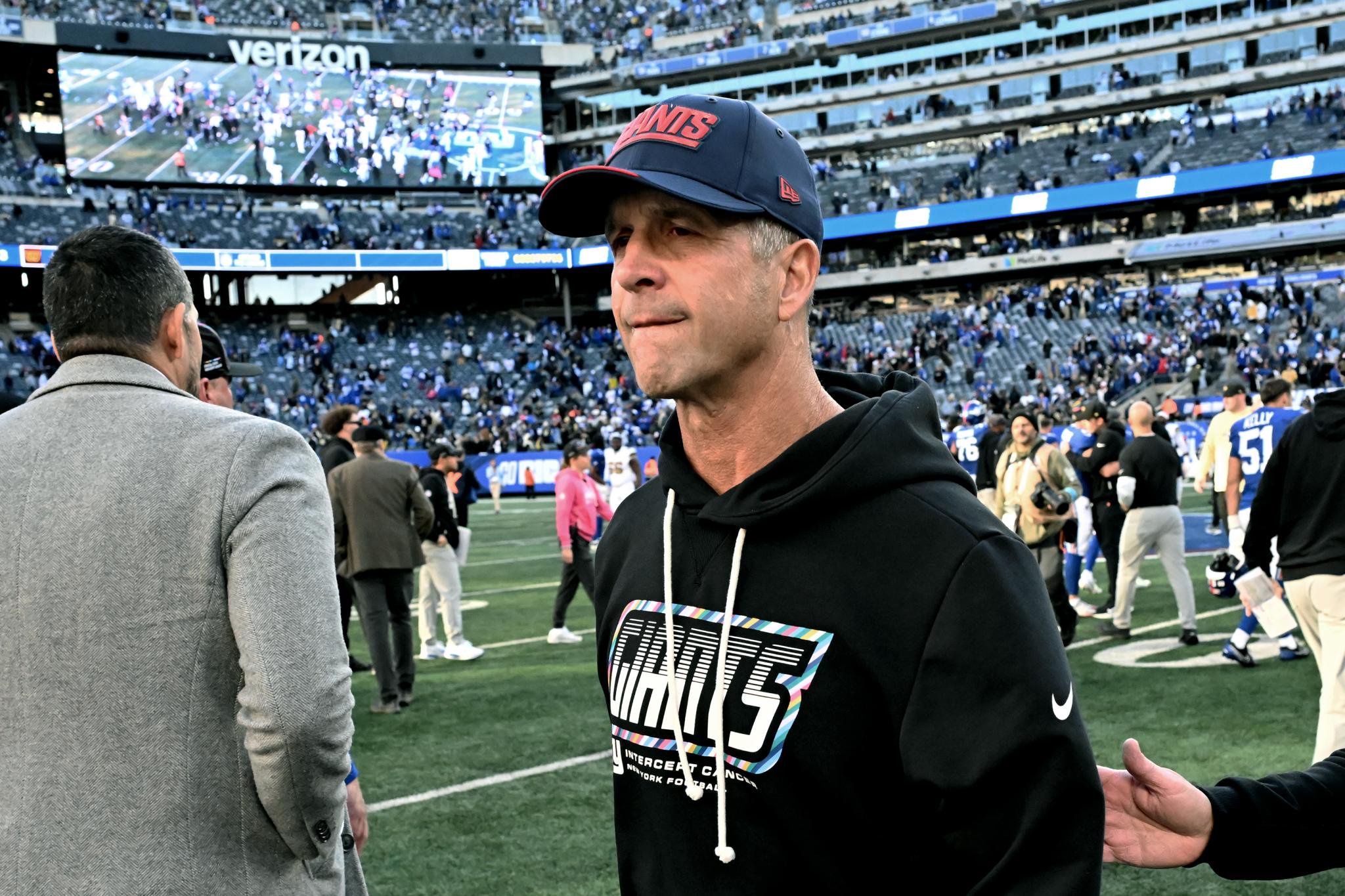 Giants head coach John Harbaugh walks off the field after the New Orleans Saints defeated the Giants 34-27 in East Rutherford, NJ.