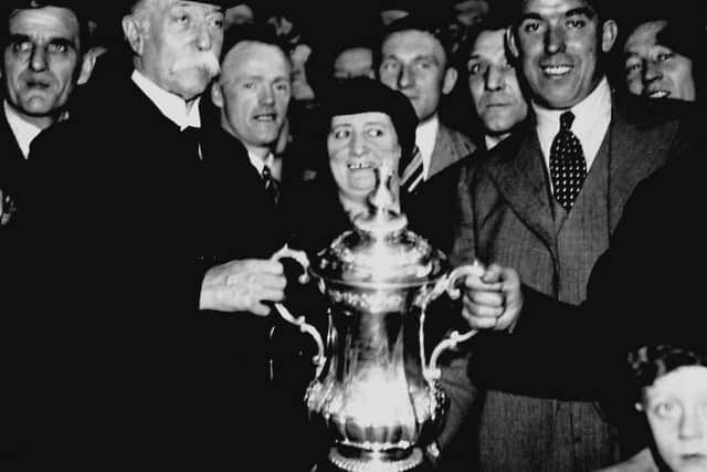 Dean, right, pictured at Euston with the FA Cup after Everton's victory against Manchester City at Wembley in 1933. He scored twice in a 3-0 win against a side that included Matt Busby. Photo: PA