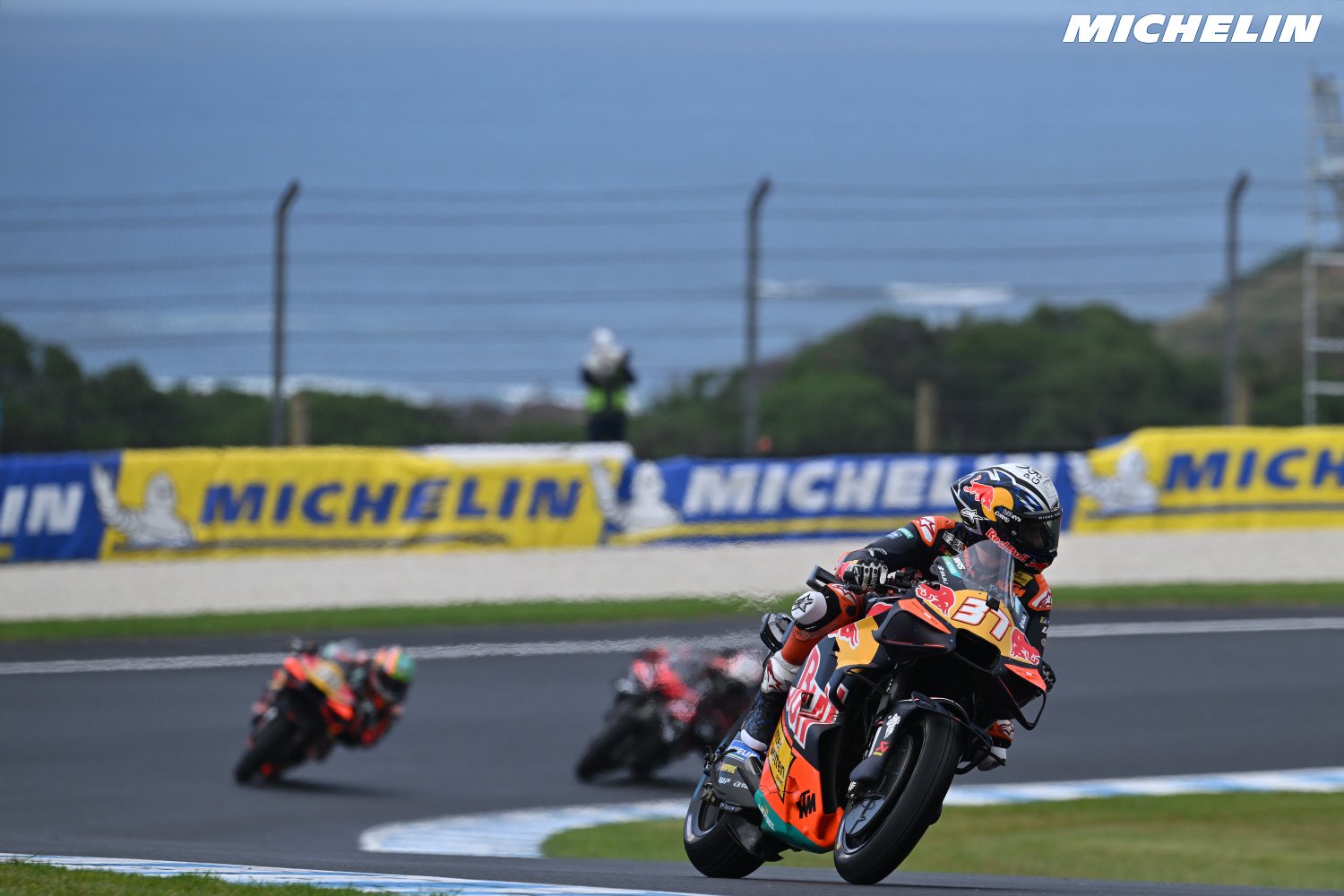 Pedro Acosta on a KTM motorcycle leaning into a corner at Phillip Island, chasing riders ahead in the MotoGP sprint