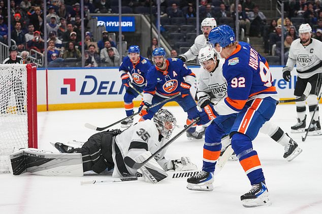Los Angeles Kings goaltender Darcy Kuemper (35) stops a shot by New York Islanders' Simon Holmstrom (92) during the second period of an NHL hockey game Thursday, Oct. 22, 2026, in Elmont, N.Y. (AP Photo/Frank Franklin II)