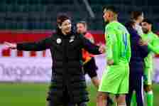 Wolfsburg's Austrian head coach Oliver Glasner (L) speaks with Wolfsburg's French defender Maxence Lacroix after the German first division Bundesli...