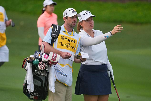Perrine Delacour of France, right, speaks with her caddie on the second hole during the first round of the LPGA Maybank Championship golf tournament in Kuala Lumpur, Malaysia, Thursday, Oct. 29, 2026. (AP Photo/Vincent Thian)