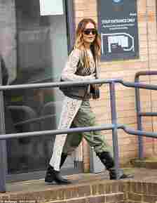 Rita layered up with a cream crochet cardigan and a grey military-style gilet as she left a studio