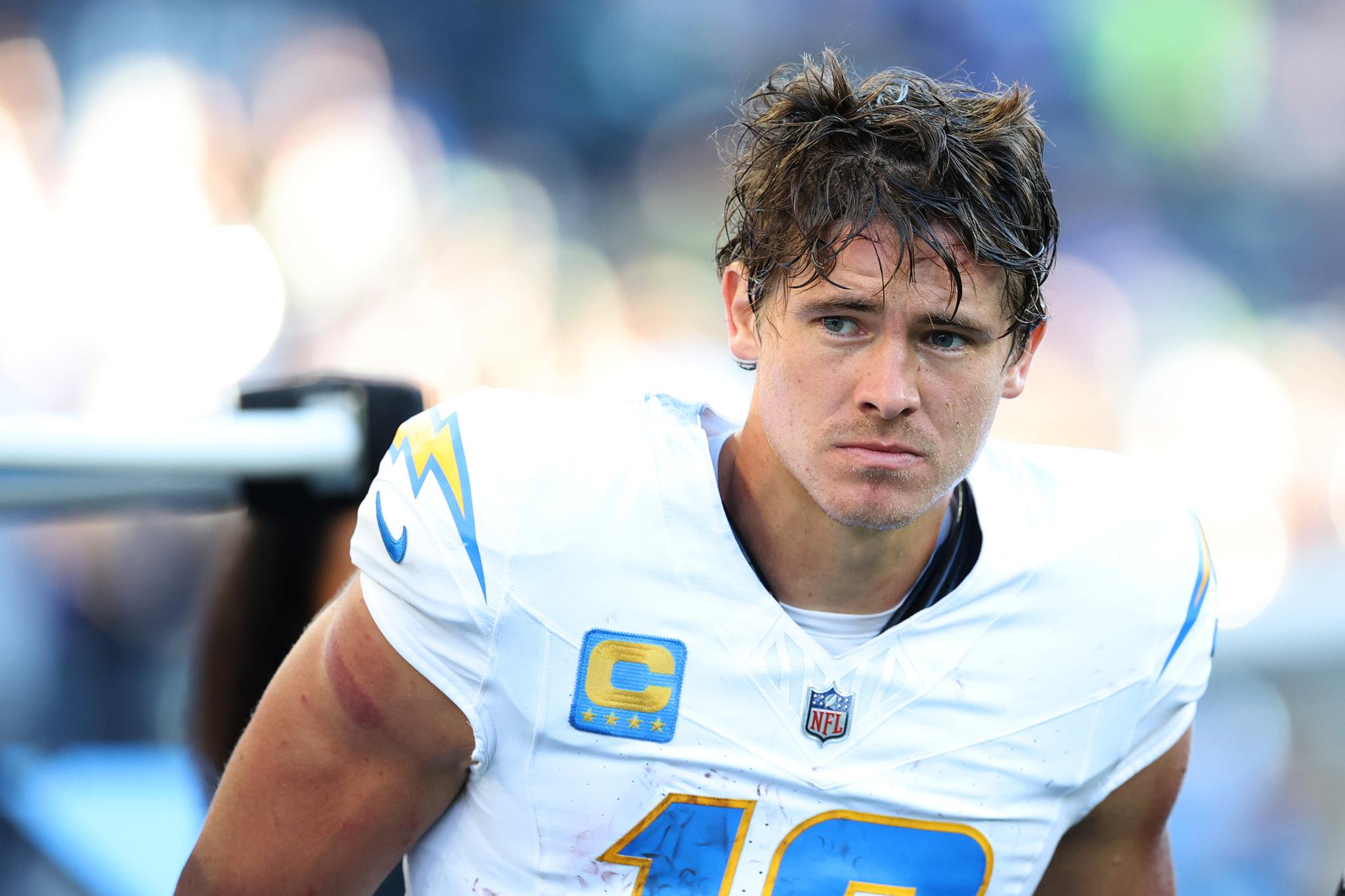 Justin Herbert #10 of the Los Angeles Chargers is escorted to the medical tent against the Seattle Seahawks during the fourth quarter at Lumen Field in Seattle, Washington, Sunday, Oct. 4, 2026.