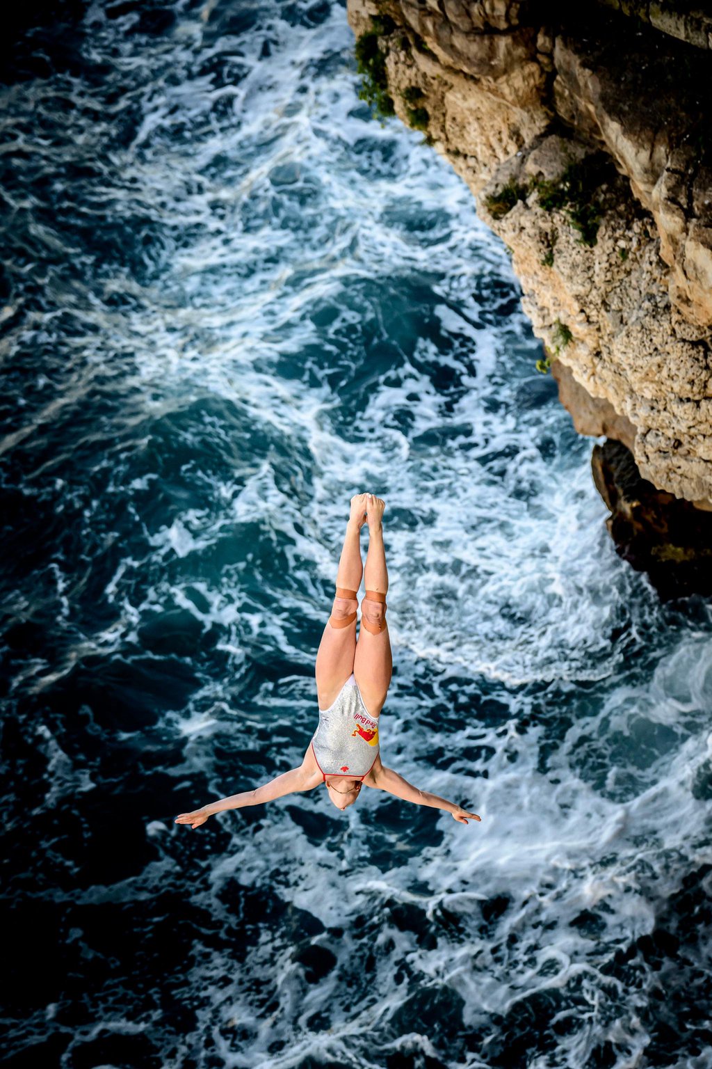 Molly Carlson dives from the 20-meter balcony during the first round of the fifth and final stop of the Red Bull Cliff Diving World Series in Polignano a Mare, Italy, on Sept. 25, 2026.