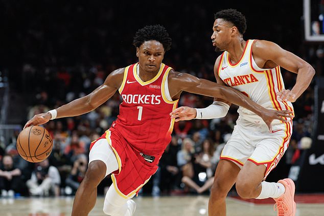 Houston Rockets guard Amen Thompson (1) drives against Atlanta Hawks guard Aaron Wiggins, right, during the first half of an NBA basketball game, Saturday, Oct. 24, 2026, in Atlanta. (AP Photo/Erik S. Lesser)