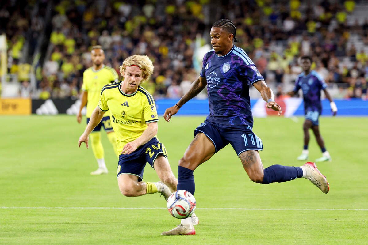 Nashville SC midfielder Eddi Tagseth (20) defends as Sporting Kansas City forward Andre Luiz (11) attacks during the first half at Geodis Park on Oct. 14, 2026.