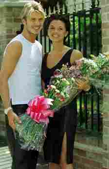 The couple with a bouquet at Posh’s parents’ home in Hertfordshire two days before their wedding
