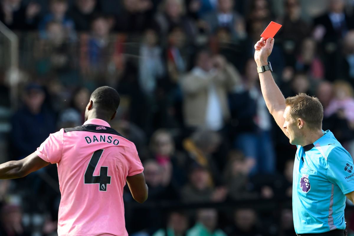 Kevin Danso is shown a red card by referee Craig Pawson 