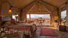 Luxury tented suite boasting a grand thatch roof, exquisite stone flooring and plenty of space