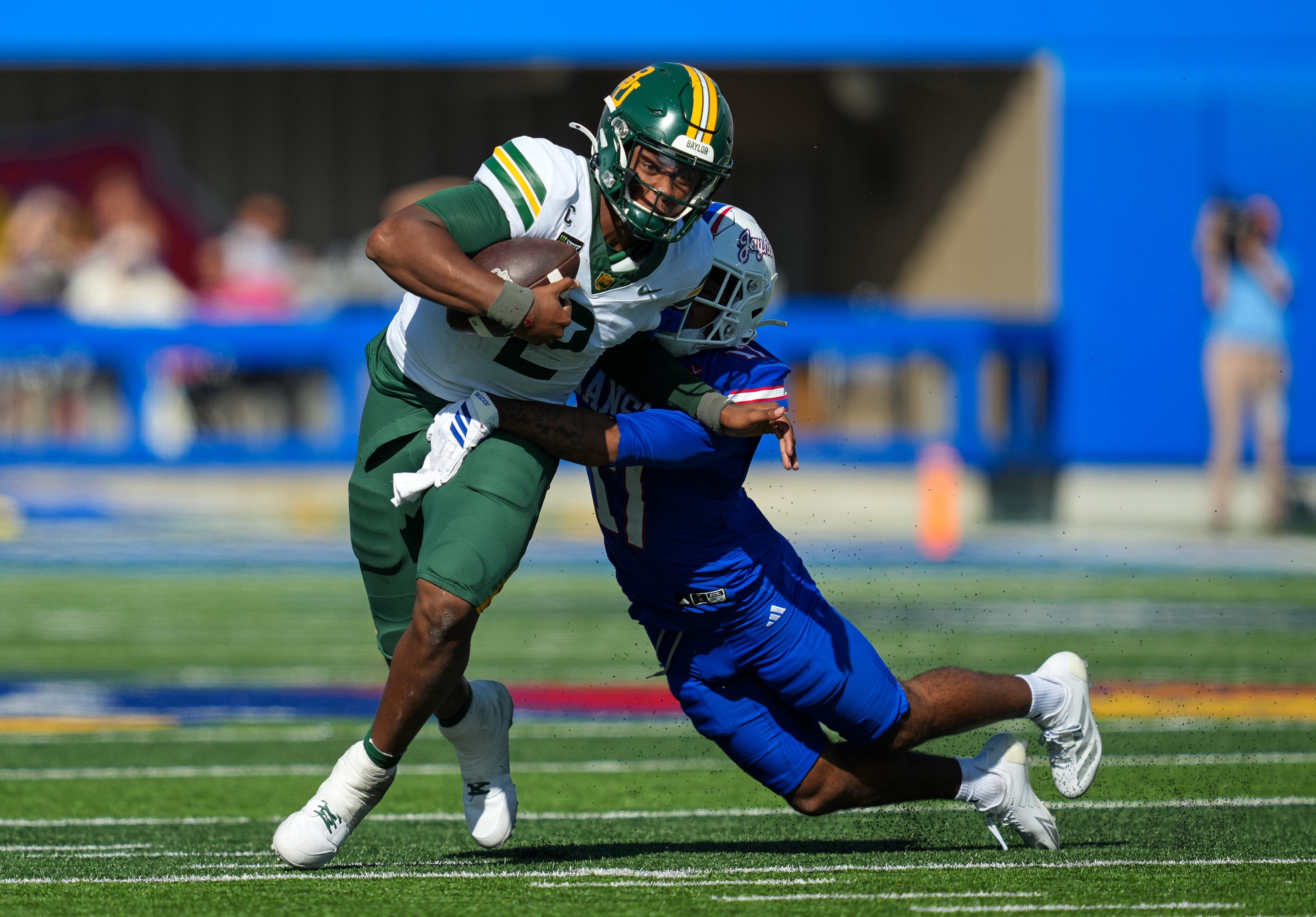 Oct 24, 2026; Lawrence, Kansas, USA; Baylor Bears quarterback DJ Lagway (2) is tackled by Kansas Jayhawks cornerback Lennie Brown III (17) during the second half at David Booth Kansas Memorial Stadium. Mandatory Credit: Jay Biggerstaff-Imagn Images