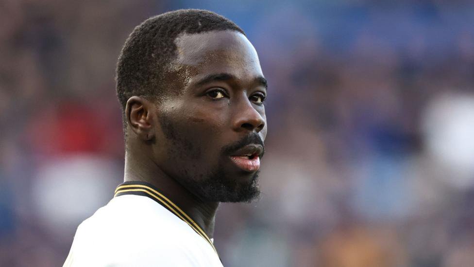 Amadou Mbengue looks to his right