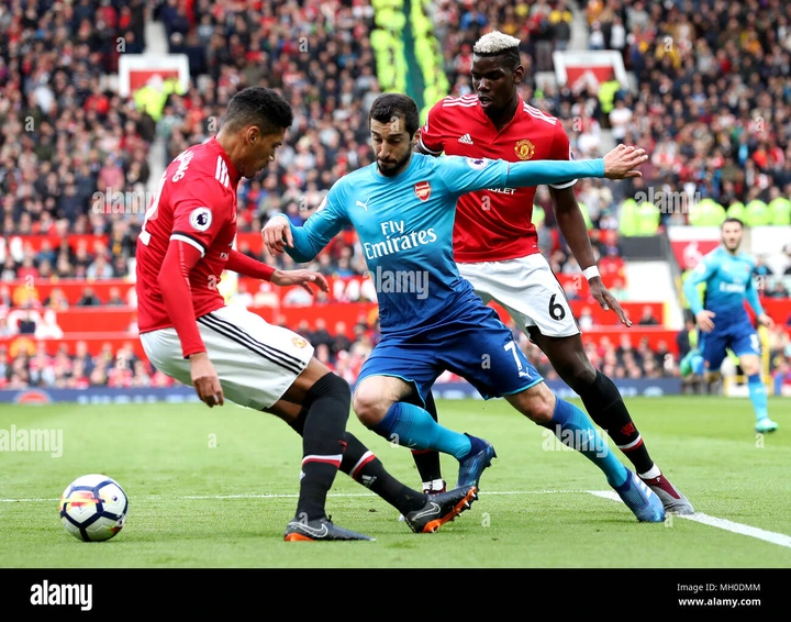 Manchester United's Paul Pogba (back) and Chris Smalling (left) battle for the ball with Arsenal's Henrikh Mkhitaryan during the Premier League match at Old Trafford, Manchester Stock Photo - Alamy