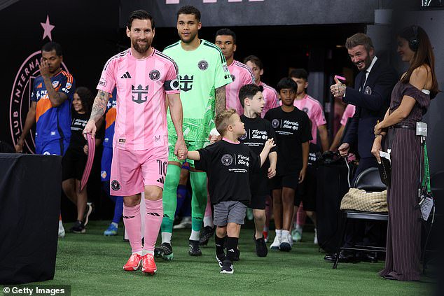 Big moment: Before the game, Huddy got the chance to walk onto the pitch with Messi