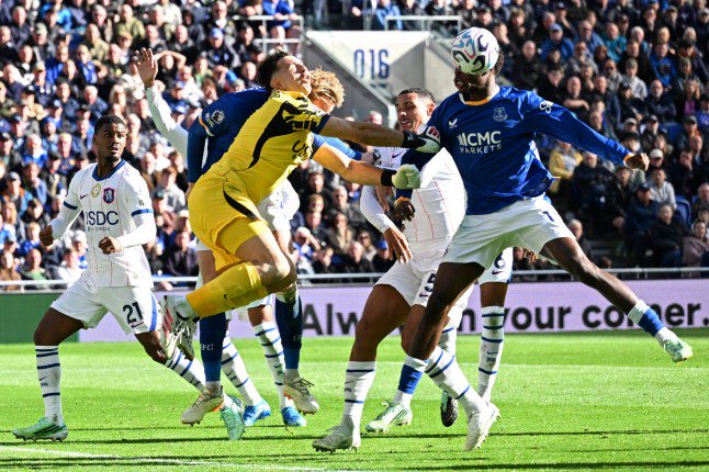 Chelsea's Argentinian goalkeeper #26 Emiliano Martinez and Everton's English defender #04 Jarrad Branthwaite clash going for the ball during the English Premier League football match between Everton and Chelsea at Hill Dickinson Stadium in Liverpool, north west England on October 17, 2026. (Photo by PETER POWELL / AFP via Getty Images) / RESTRICTED TO EDITORIAL USE. No use with unauthorized audio, video, data, fixture lists, club/league logos or 'live' services. Online in-match use limited to 120 images. An additional 40 images may be used in extra time. No video emulation. Social media in-match use limited to 120 images. An additional 40 images may be used in extra time. No use in betting publications, games or single club/league/player publications. /