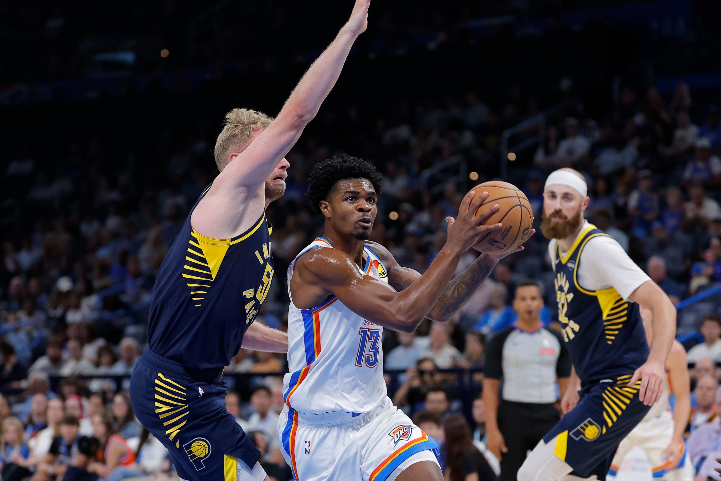 Oct 13, 2026; Oklahoma City, Oklahoma, USA; Oklahoma City Thunder guard Otega Oweh (13) drives to the basket past Indiana Pacers Rienk Mast during the second half at Paycom Center. Mandatory Credit: Alonzo Adams-Imagn Images