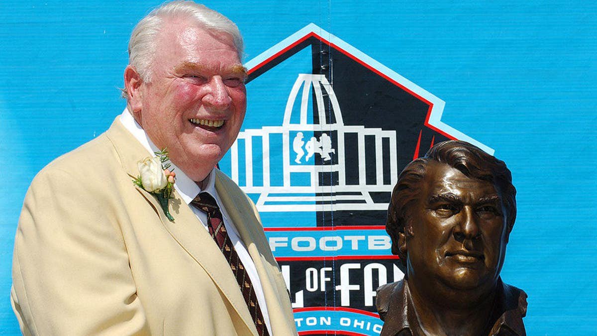 John Madden poses with his Pro Football Hall of Fame bust.