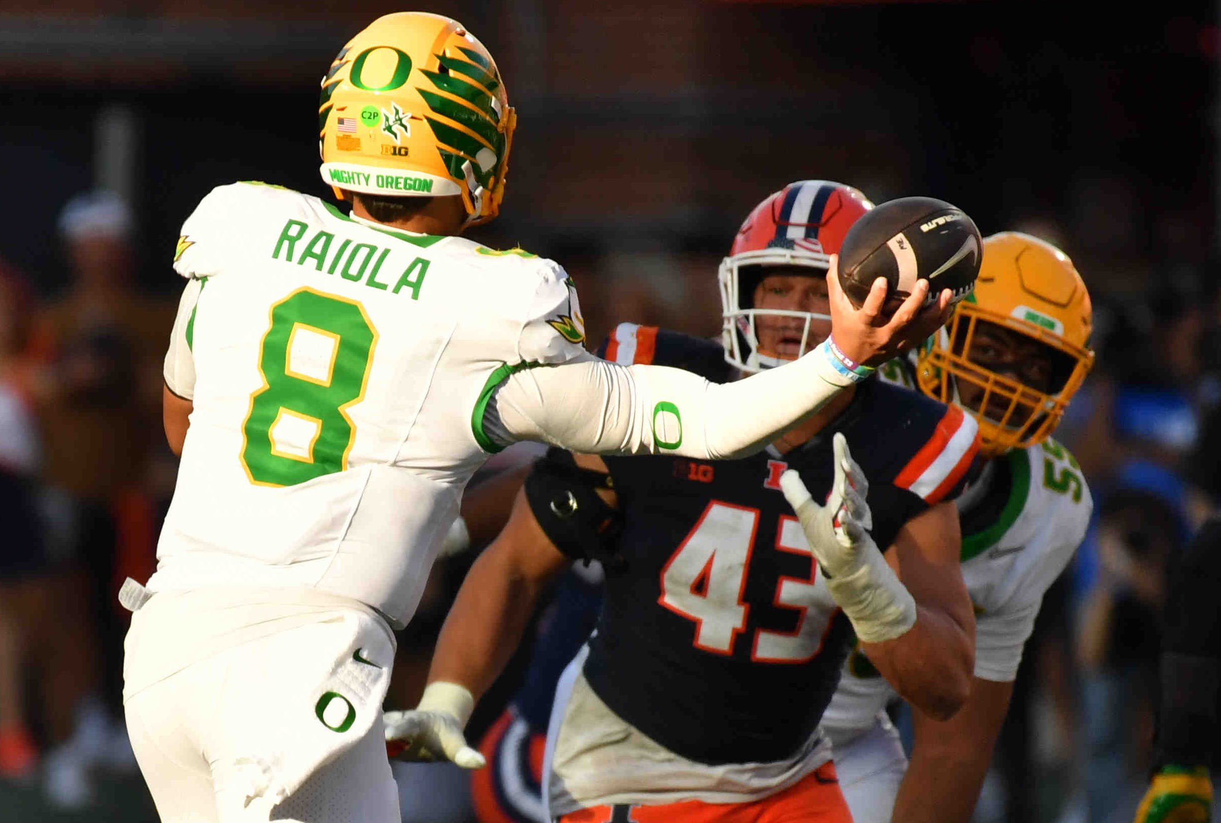 Oct 24, 2026; Champaign, Illinois, USA;  Oregon Ducks quarterback Dylan Raiola (8) passes the ball as Illinois Fighting Illini defensive lineman Joe Barna (43) defends during the second half at Gies Memorial Stadium.  Mandatory Credit: Ron Johnson-Imagn Images