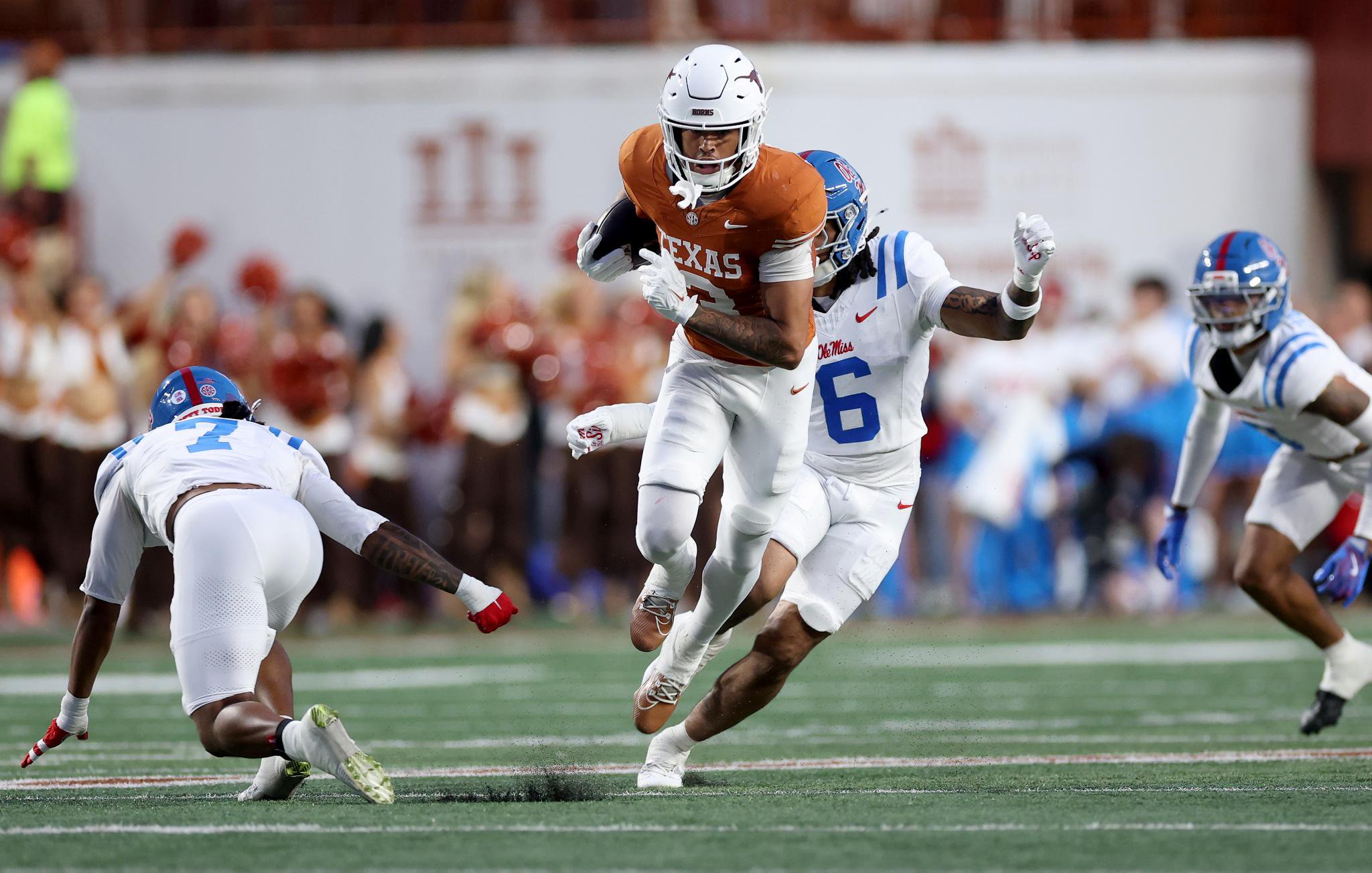 Emmett Mosley V. of the Texas Longhorns runs after a catch against Joenel Aguero of the Ole Miss Rebels during a college football game.