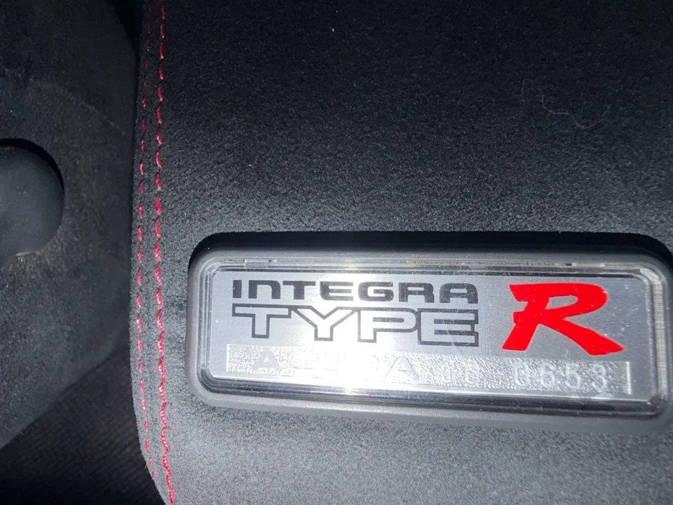 Numbered Integra Type R build plaque on the center armrest of a 2000 Acura Integra Type R
