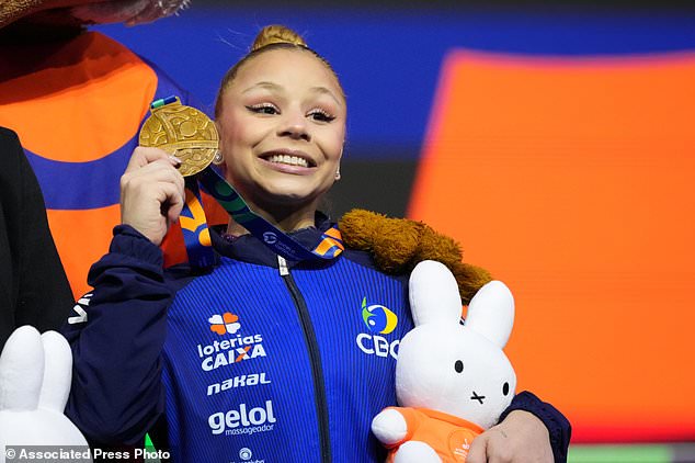 Flavia Saraiva, of Brazil, poses on the podium after winning the bronze medal in the beam during the apparatus finals at the Artistic Gymnastics World Championships in Rotterdam, the Netherlands, Sunday, Oct. 25, 2026. (AP Photo/Patrick Post)