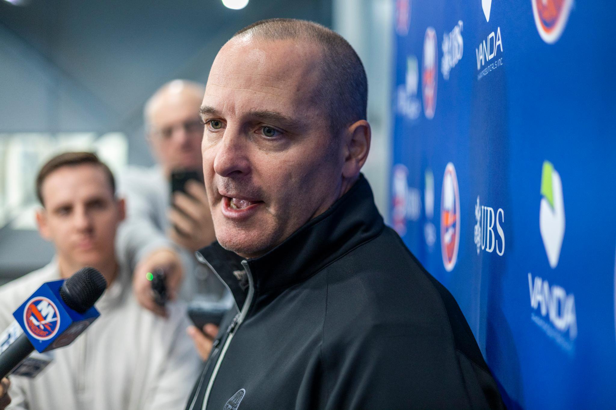 New York Islanders general manager Mathieu Darche speaks with reporters during training camp.