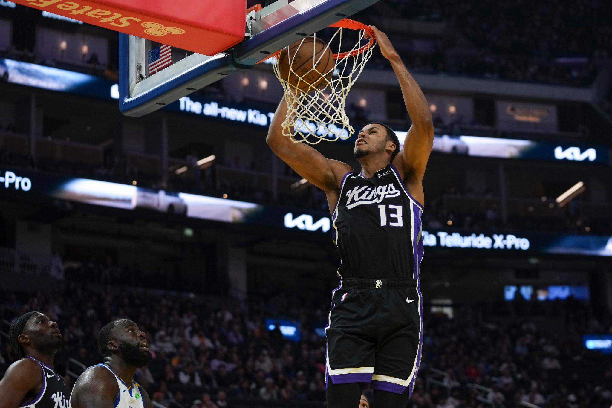 Sacramento Kings player dunks the basketball during a game against the Golden State Warriors.