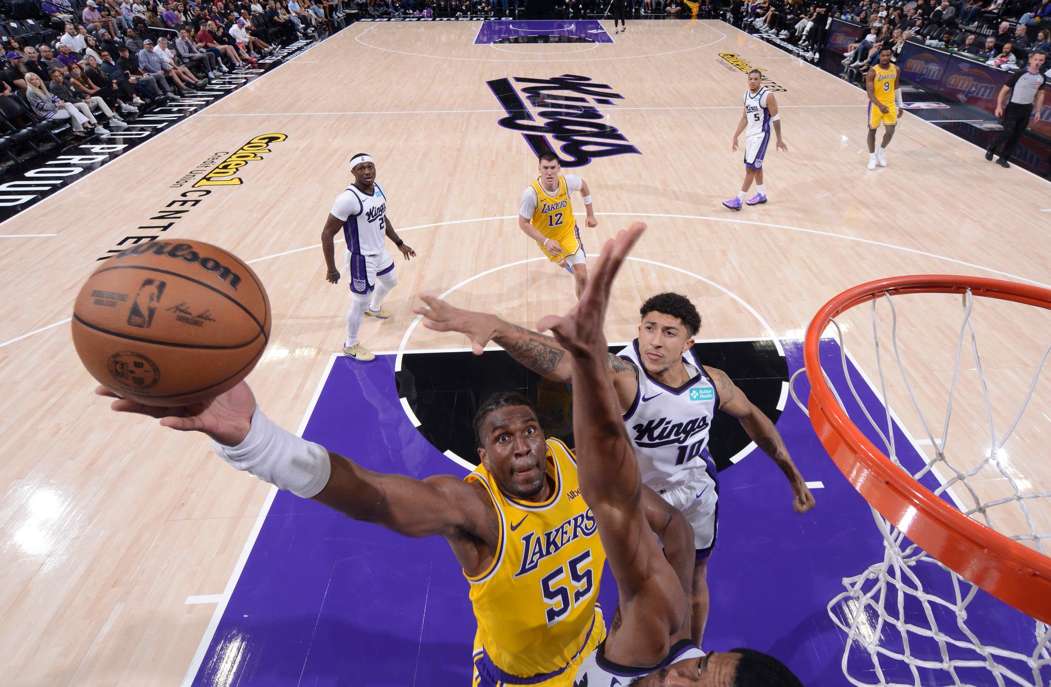 Los Angeles Lakers forward Kevon Looney (55) drives to the basket during an NBA game against the Sacramento Kings.
