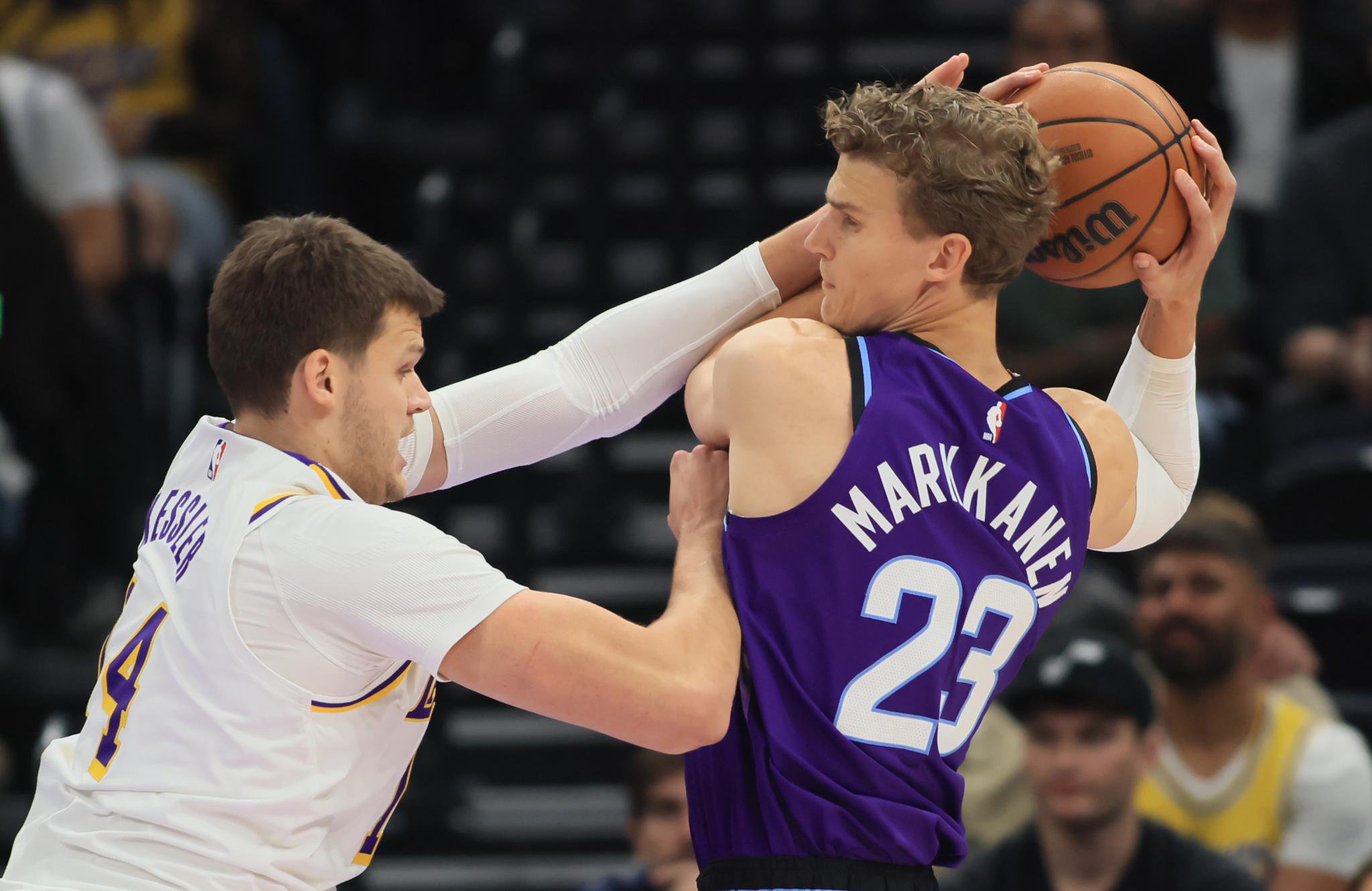 Lauri Markkanen of the Utah Jazz grabs a rebound away from Walker Kessler of the Los Angeles Lakers.