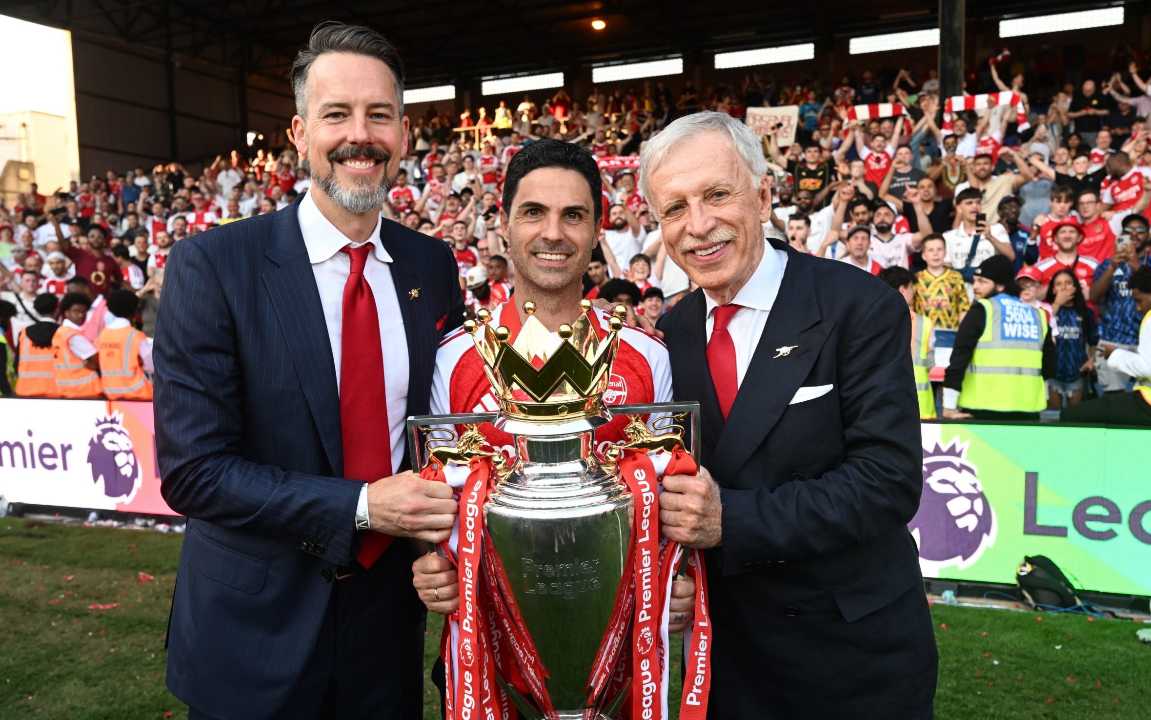 Mikel Arteta with the Premier League trophy alongside Josh and Stan Kroenke