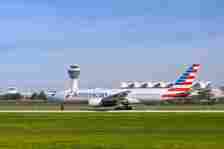 An American Airlines Boeing 777-223ER with the aircraft registration N776AN is starting on the southern runway 26L of the Munich airport MUC EDDM