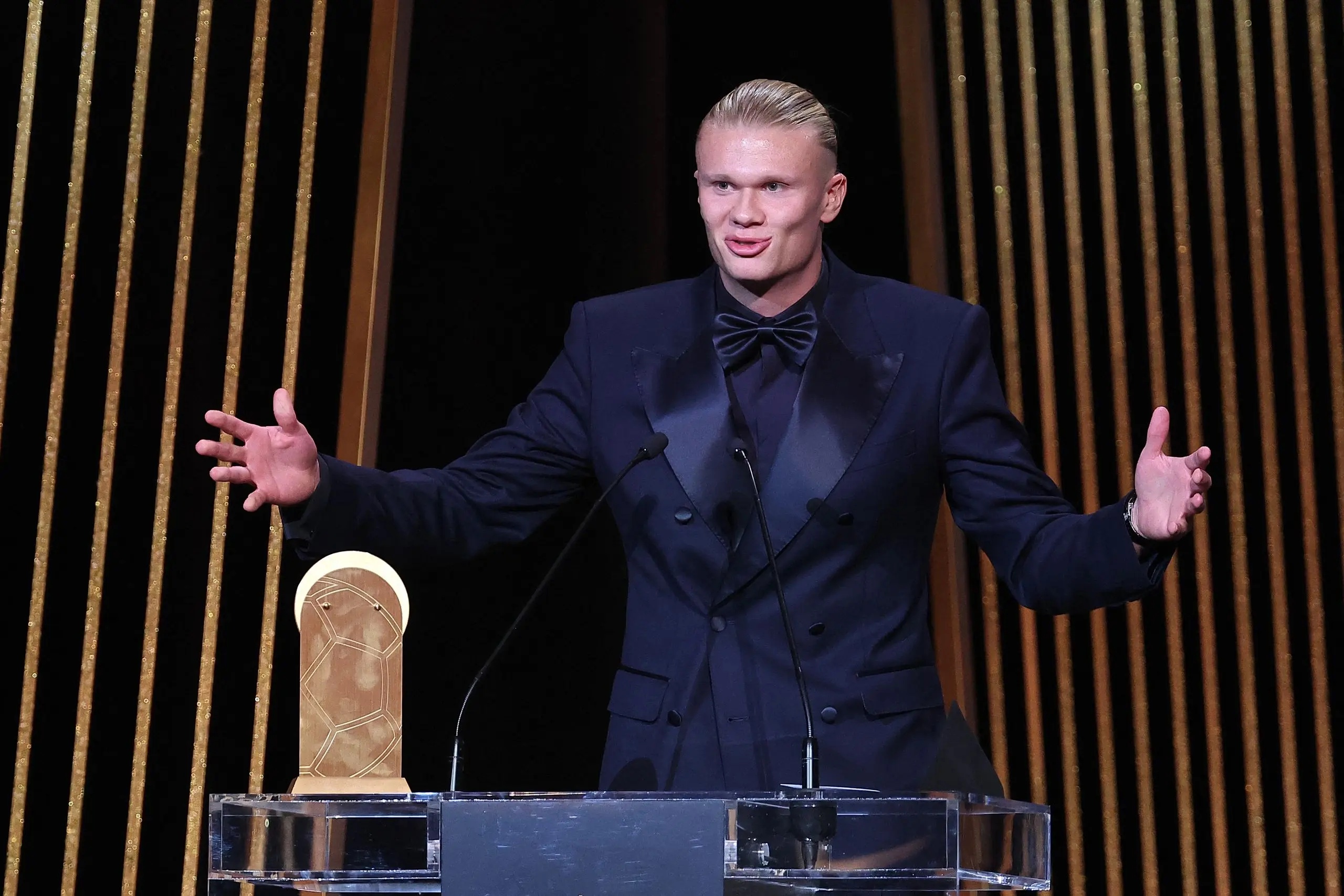 Manchester City's Norwegian forward Erling Haaland gestures on stage as he receives the Gerd Muller Trophy.