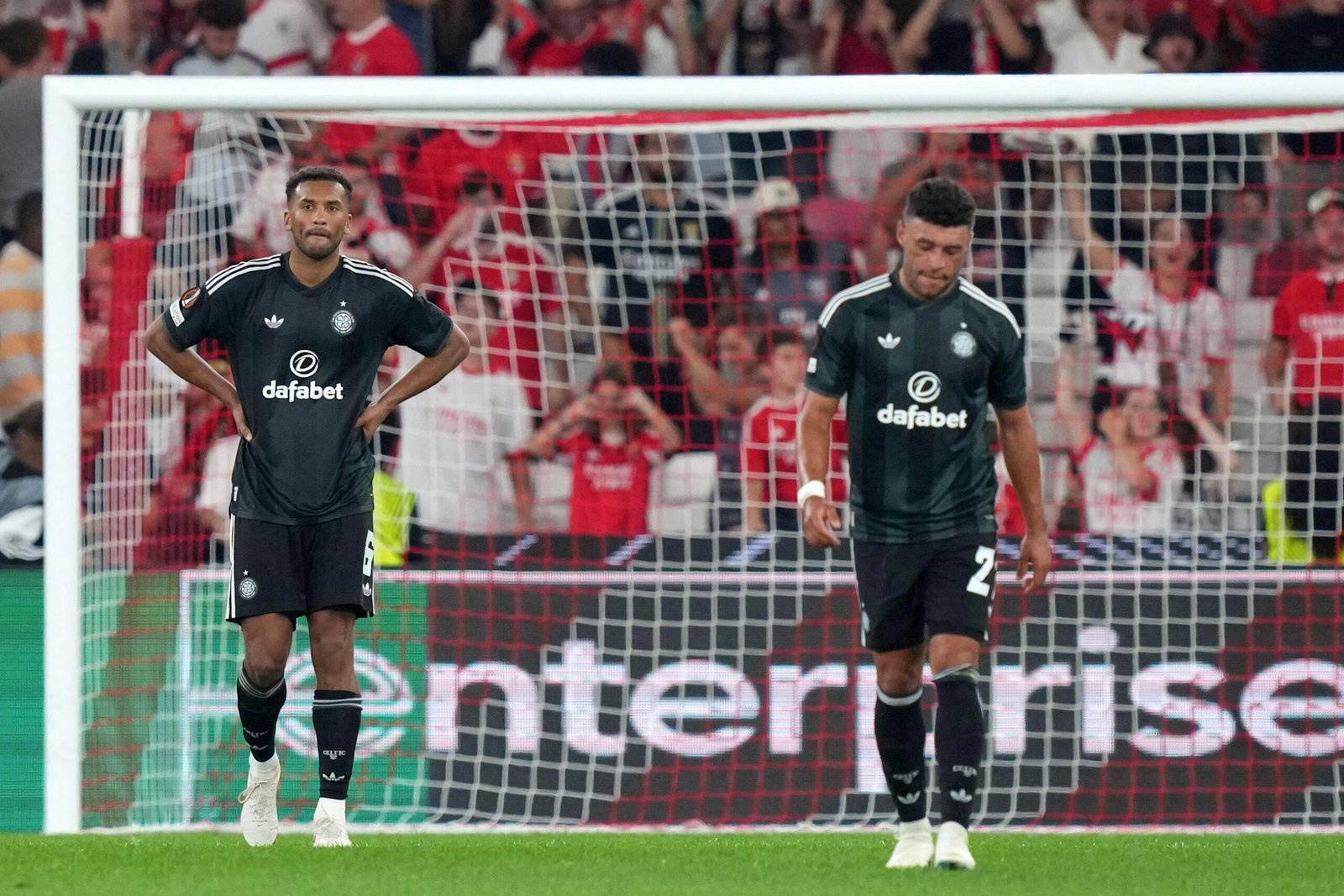 Celtic's Auston Trusty and Alex Oxlade-Chamberlain react after Benfica's fourth goal in Lisbon