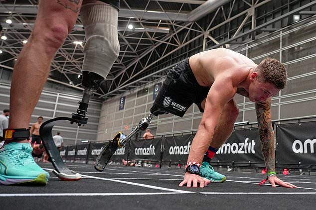 Ukrainian veterans Oleksii Doroshenko, left, and Ivan Artiukh compete in the adaptive division during the HYROX event in Valencia, Spain, Sunday, Oct. 18, 2026. (AP Photo/Alberto Sáiz)