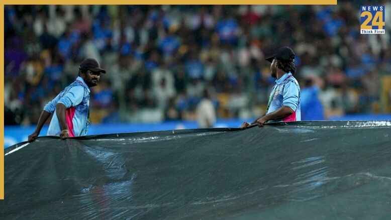 Ground staff cover the pitch after rain interrupted play during the fifth and final T20I cricket match of the series between India and West Indies (Image Credit - PTI)