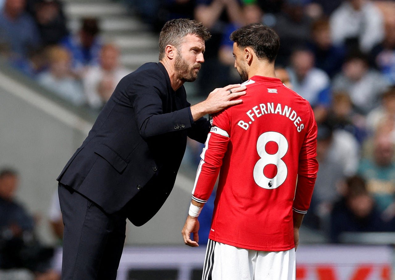 Manchester United manager Michael Carrick speaks to Bruno Fernandes (Reuters)